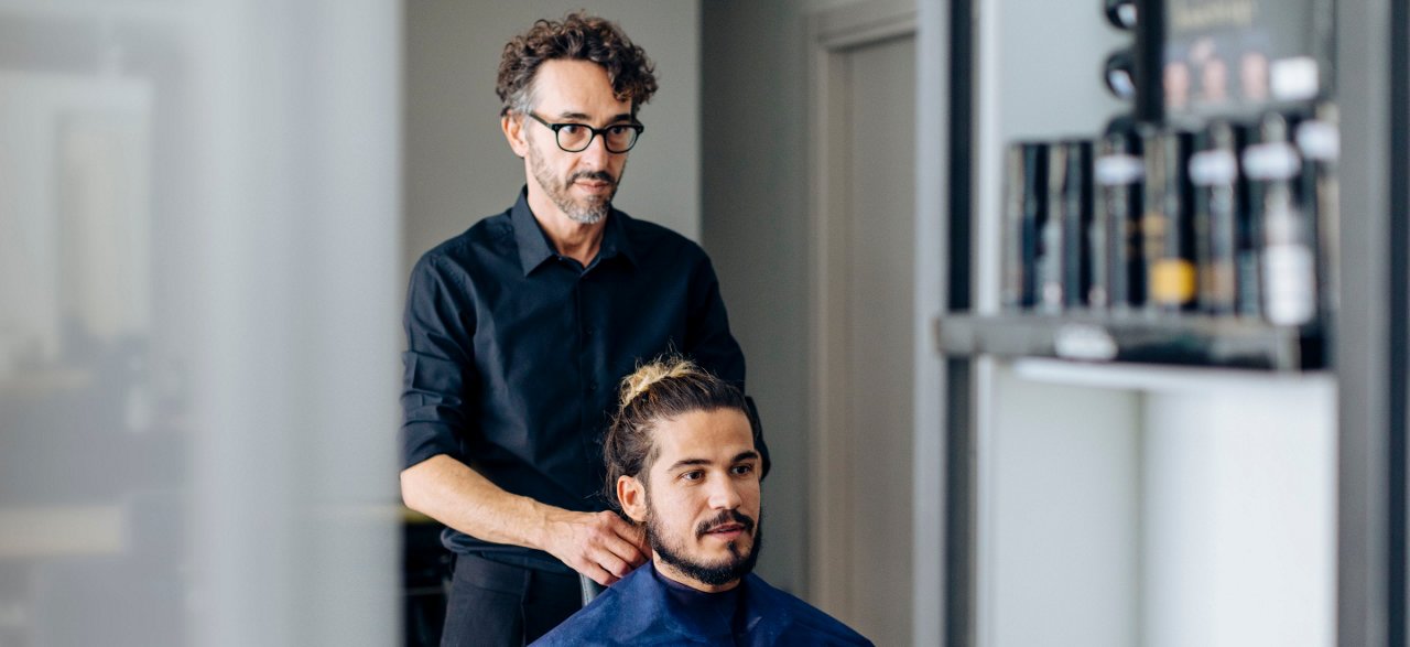 Man at hairdresser consulting with client