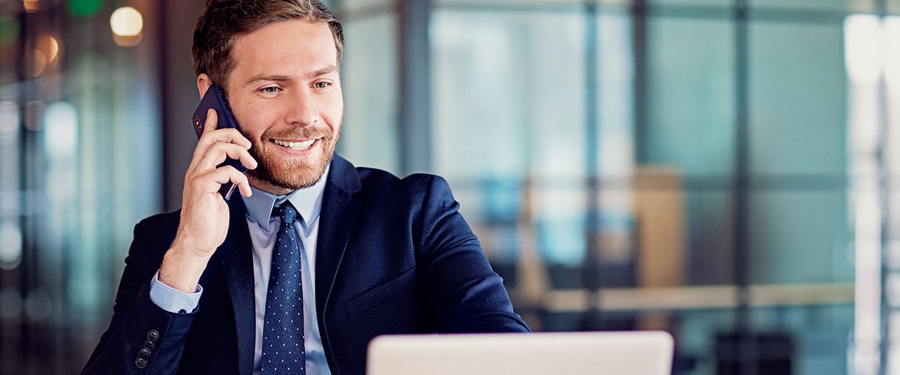 Adviser sitting at desk talking on phone