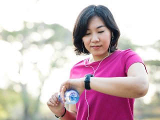 Lady looking at watch while exercising