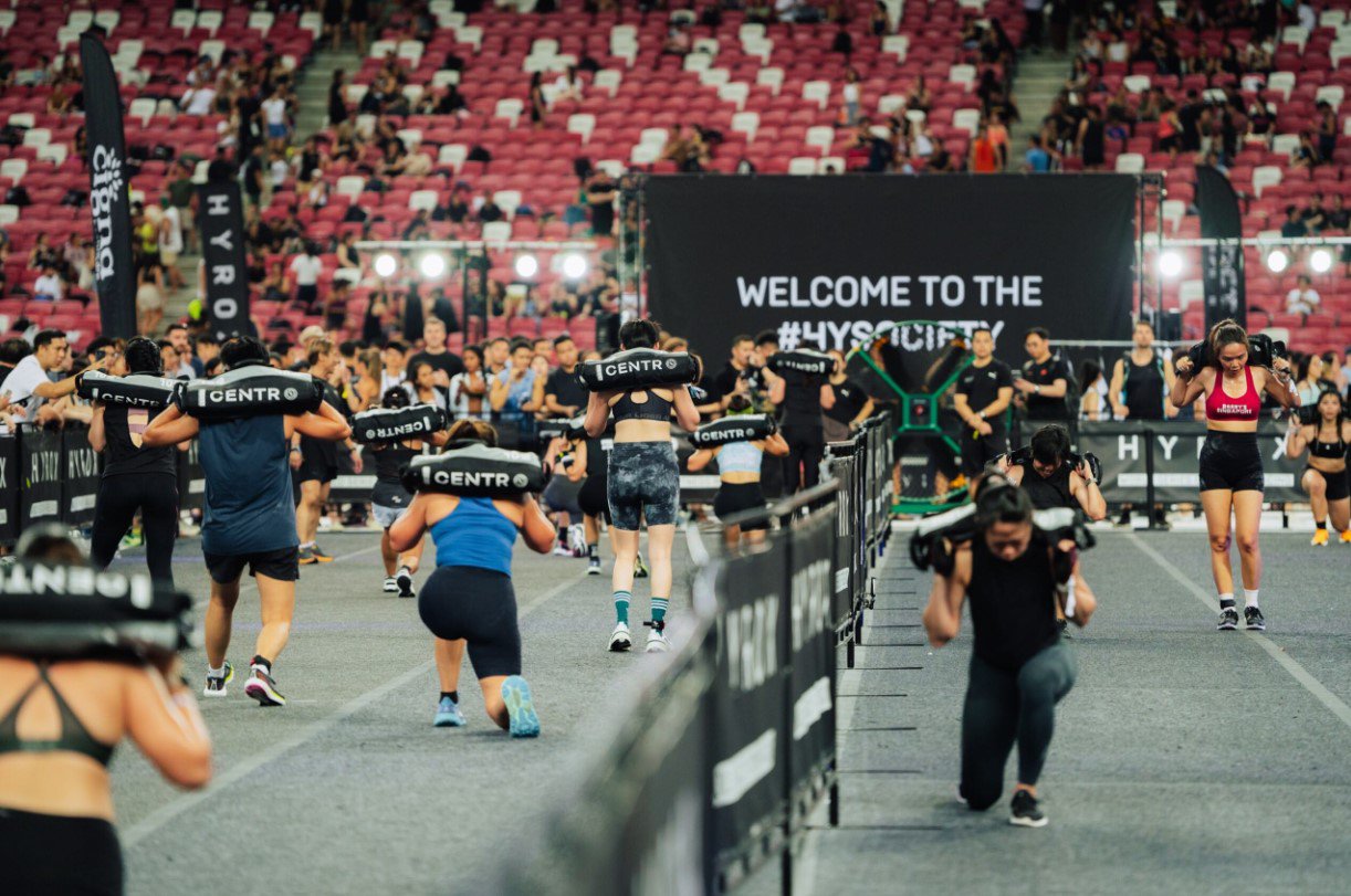 Participants on rowing machines during HYROX