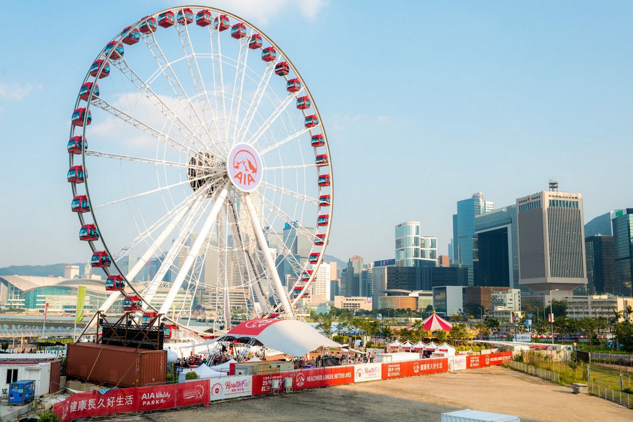A large ferris wheel stands tall against a clear blue sky