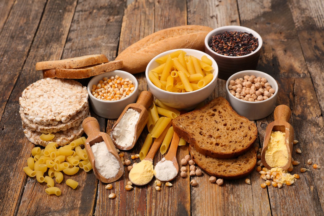 A selection of gluten and gluten-free foods on a wooden base