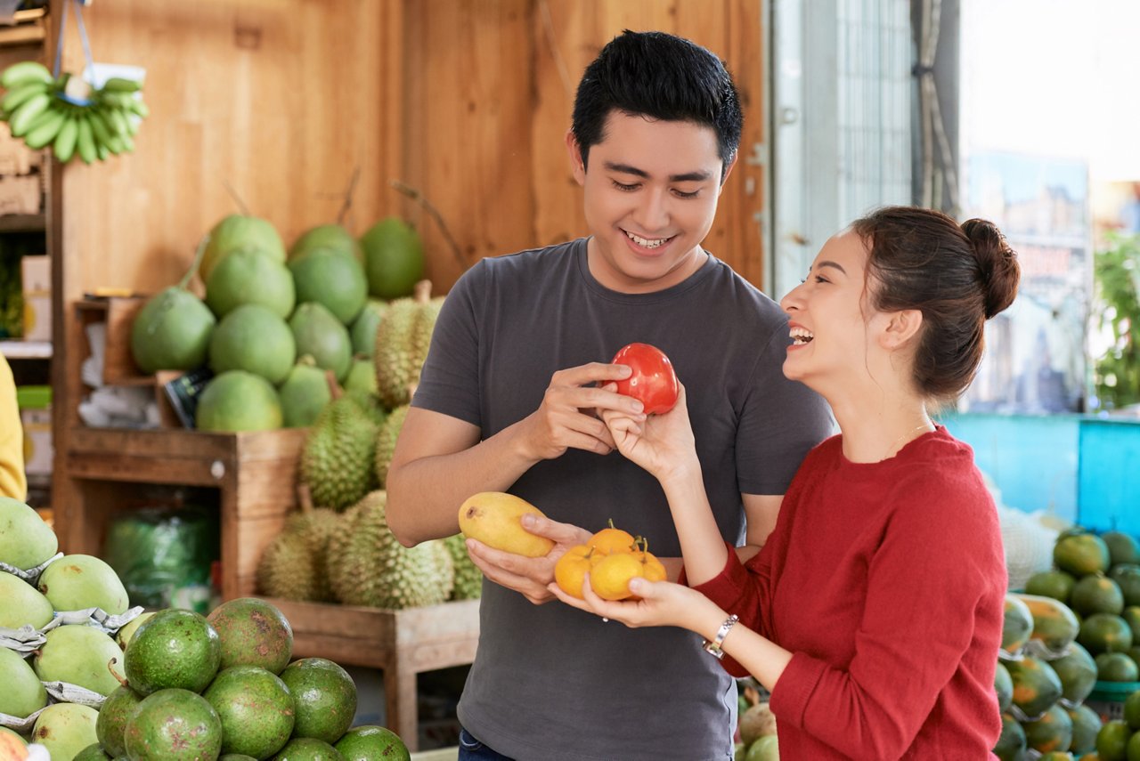 Smiling couple at a fruit store