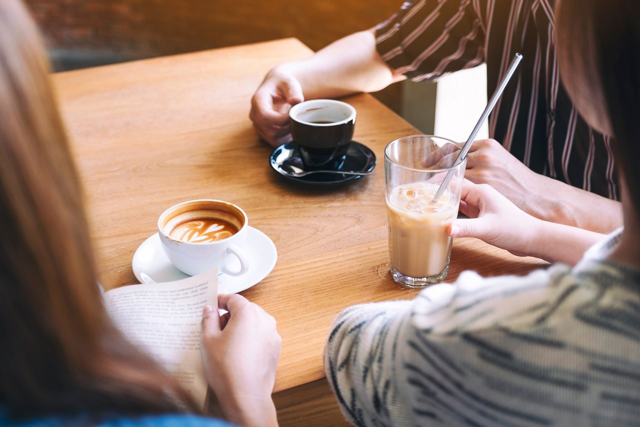 Closeup shot of people drinking coffee in a café