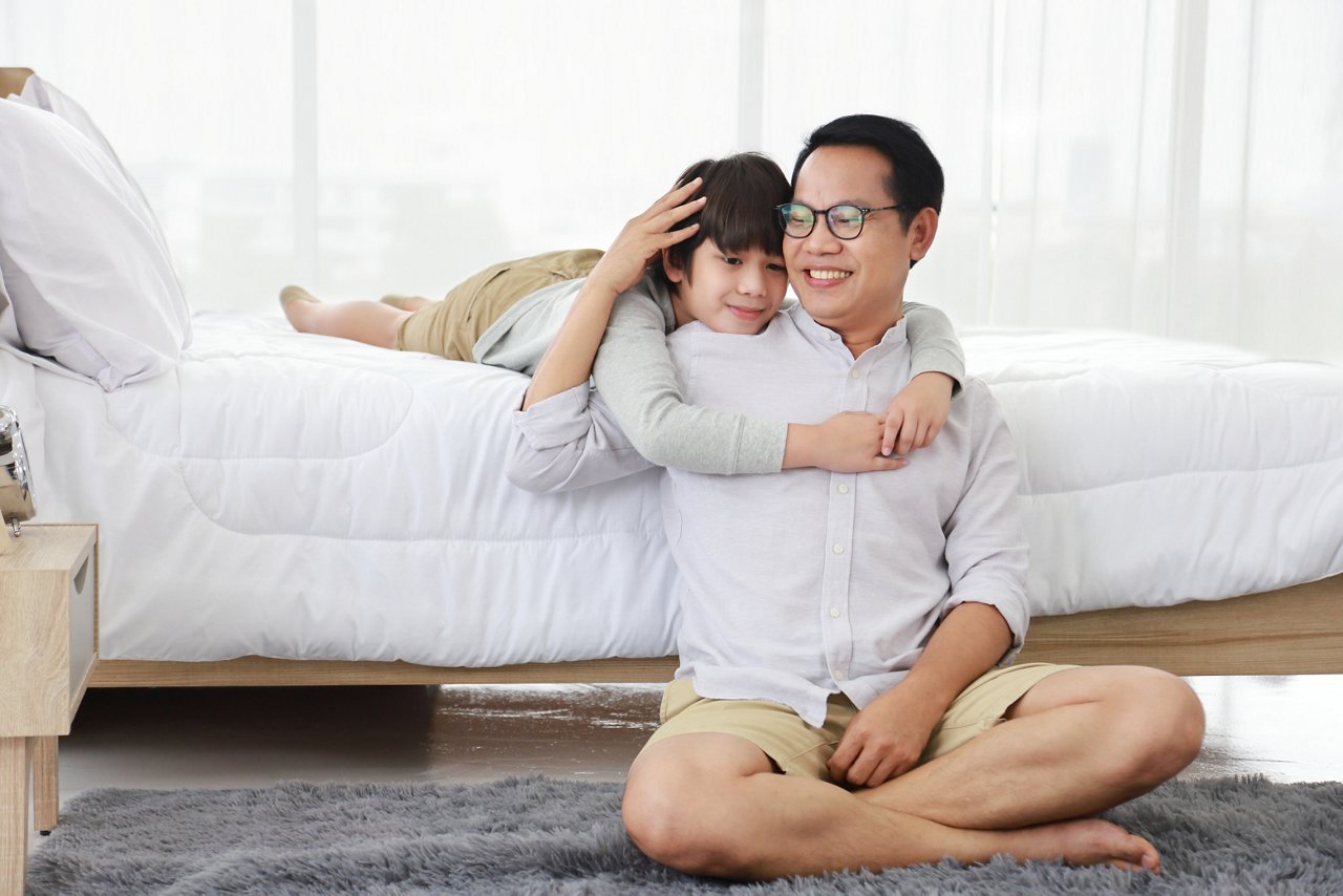 A father and son spending time together in a bedroom