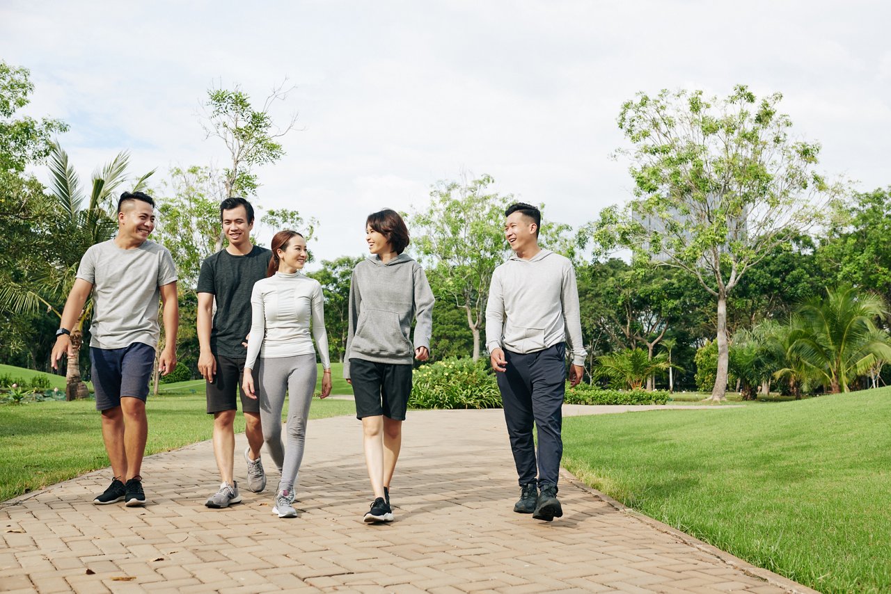 A group of people walk on a path outdoors.