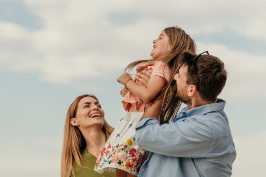 Family outdoors smiling