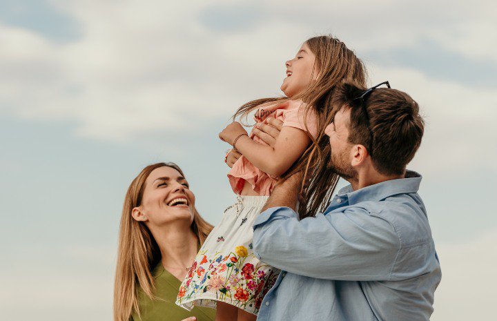 Family outdoors smiling