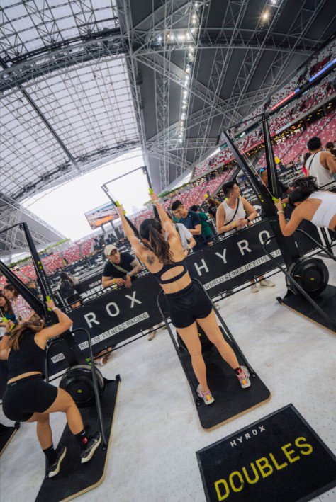 Woman using a ski machine during a HYROX workout.