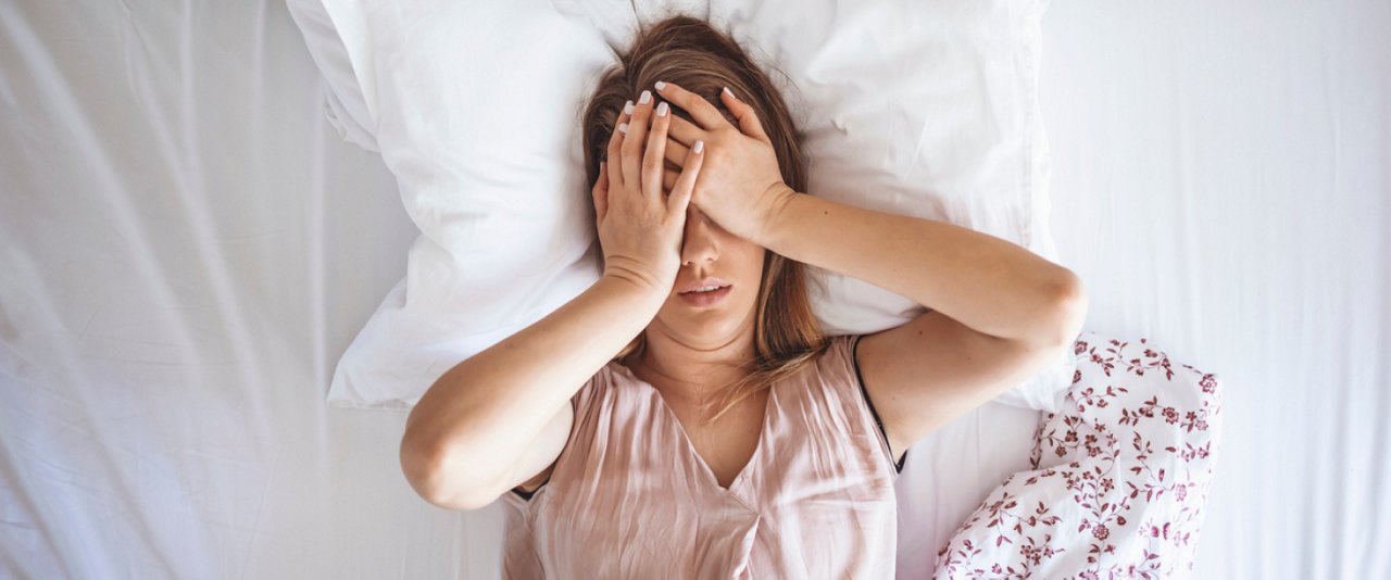 Anxious woman in bed