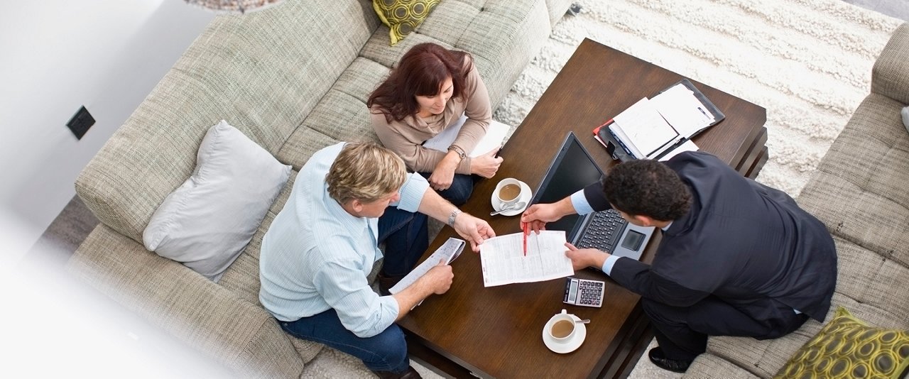 Couple with adviser going through documents