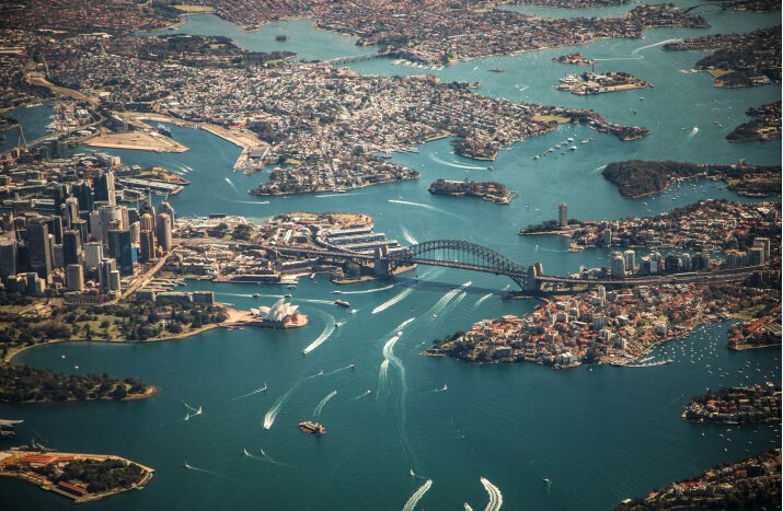 Aerial view of Sydney Harbour showcasing the iconic skyline and vibrant waters, highlighting the city's beauty and layout.