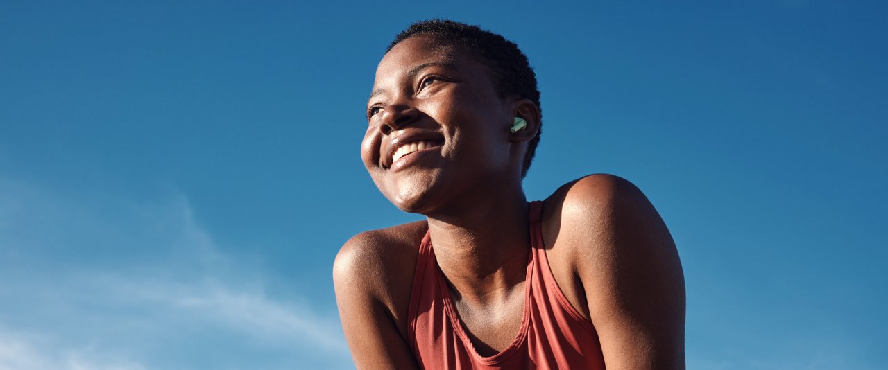 A woman smiles joyfully while standing