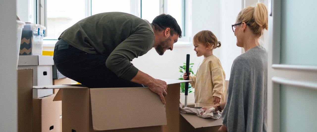 Couple with child while packing boxes
