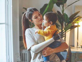 Lady with prosthetic arm holding child