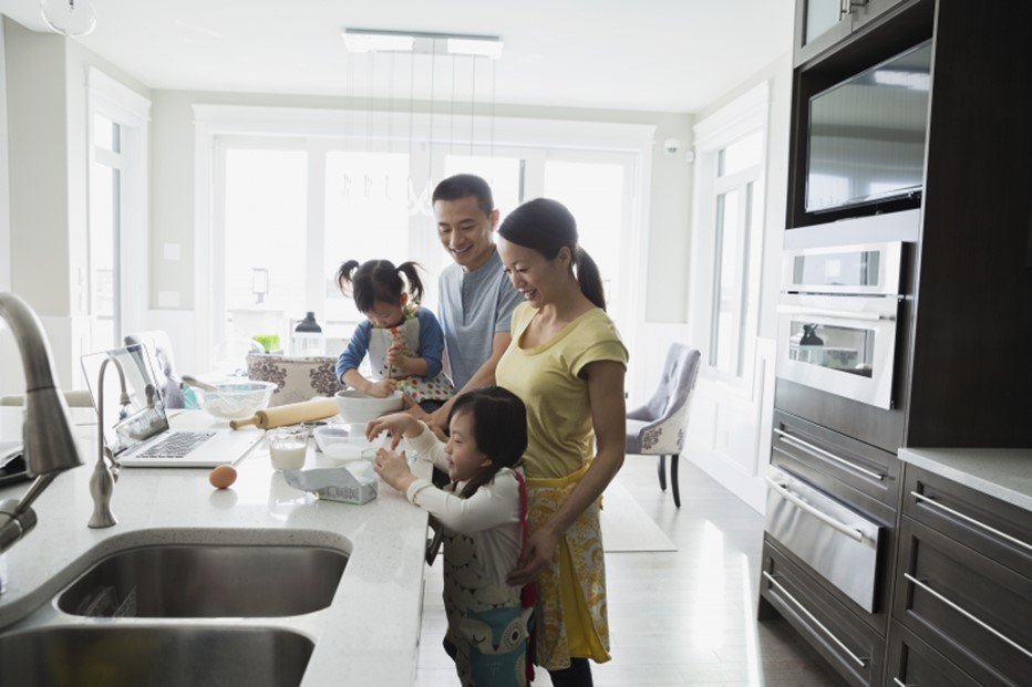 Asian family of four baking in the kitchen 