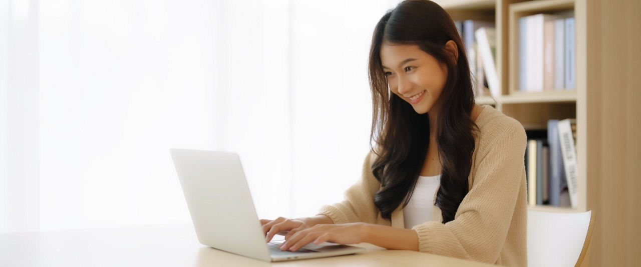 Young Asian woman pauses while taking a quiz on types of insurance. 