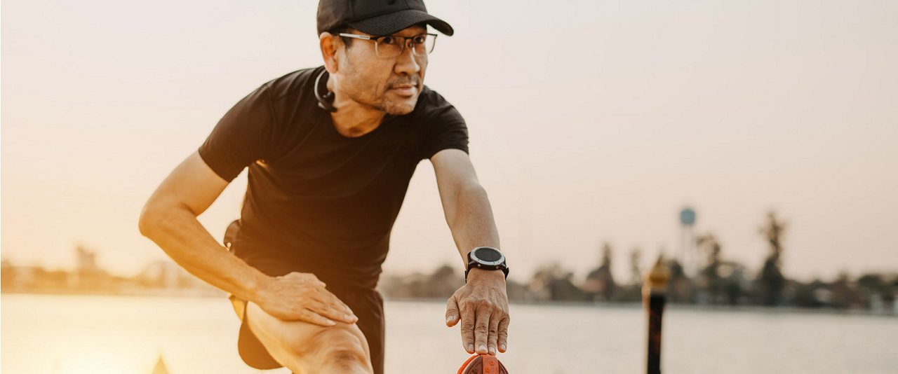 Man stretching while on a run