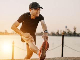 Man stretching while on a run