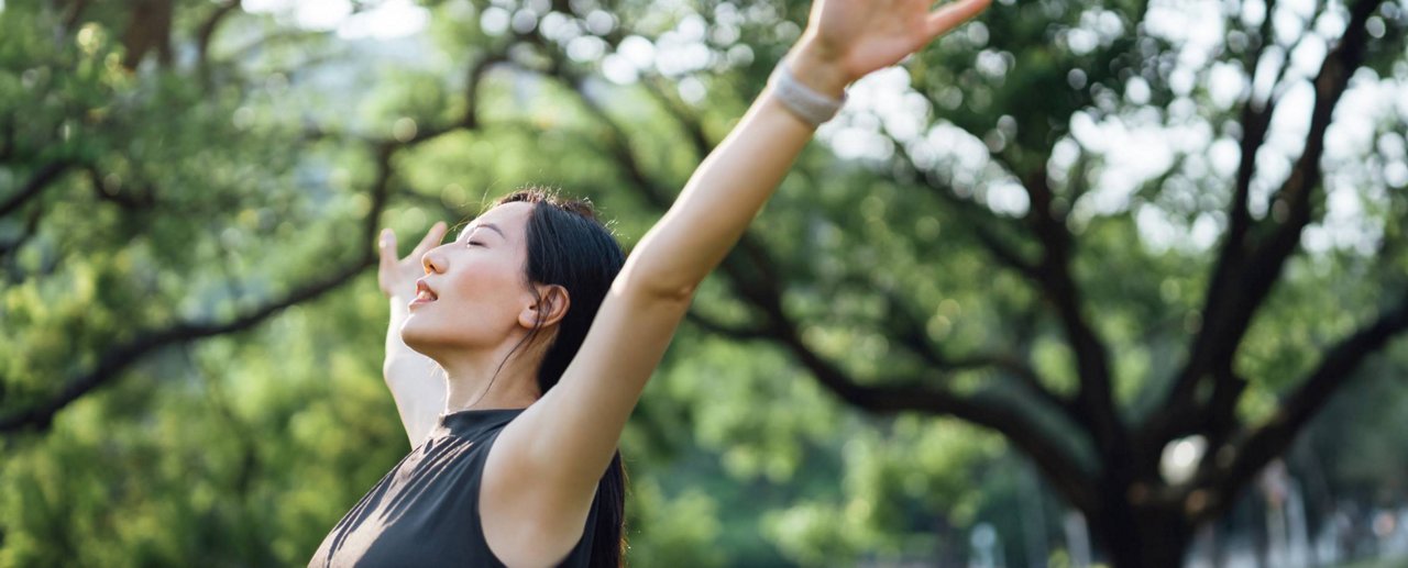 Lovely Asian girl and mother celebrating birthday with friends / family by having a virtual birthday party at home. Enjoying birthday celebration in front of the laptop during pandemic. Practicing social distancing. Birthday lifestyle theme