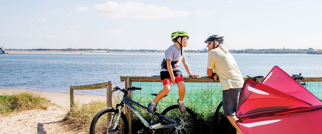 Two cyclists near a waterfront, capturing a peaceful outdoor experience.