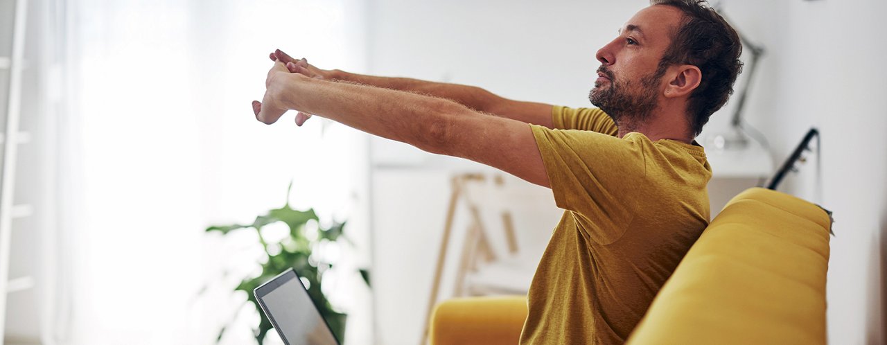 a man sitting and stretching arms