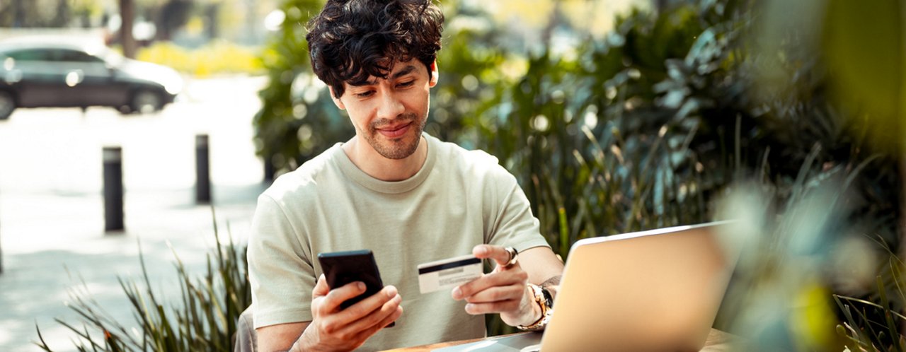 a man holding a mobile and a card