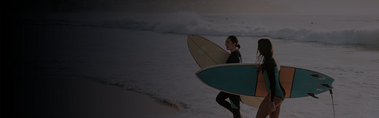 ladies holding surfboards