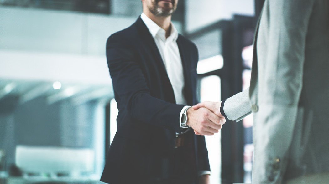 two persons shaking hands