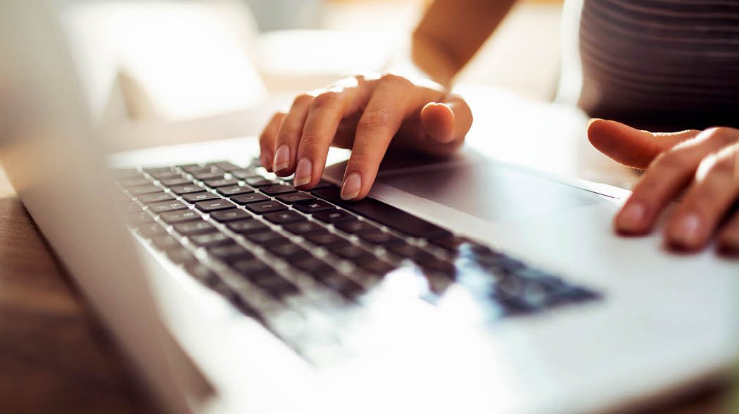 a person typing on a laptop