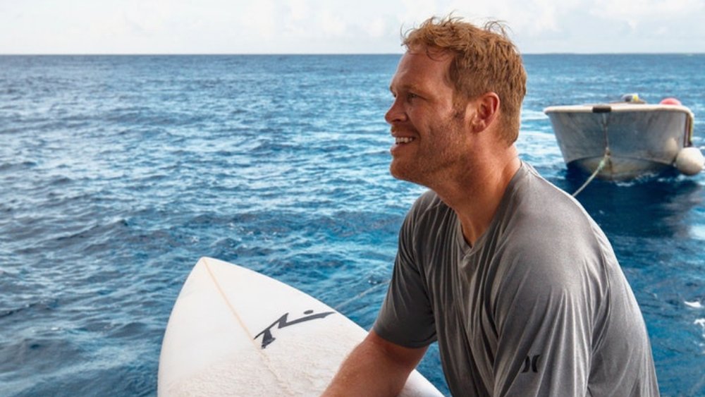 a man sitting on a surfing board