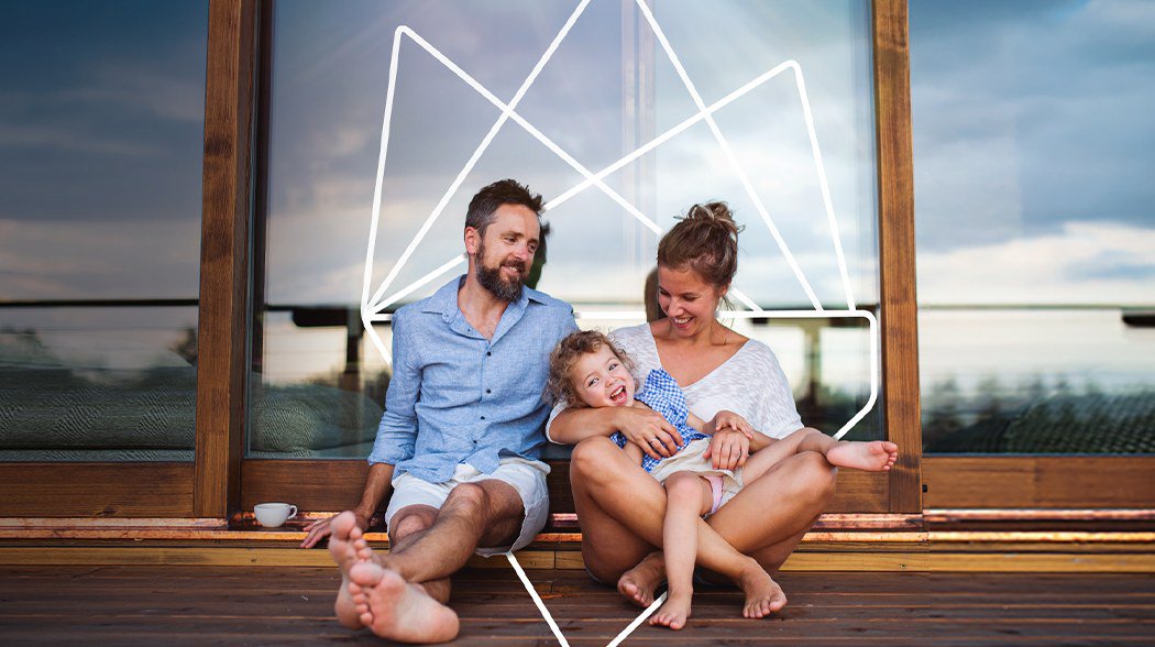 a family sitting down near large window