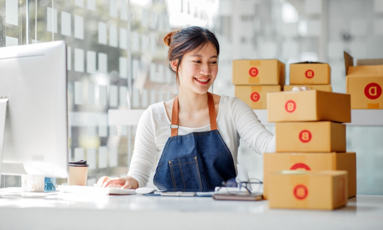 Female entrepreneur prepares boxes for delivery