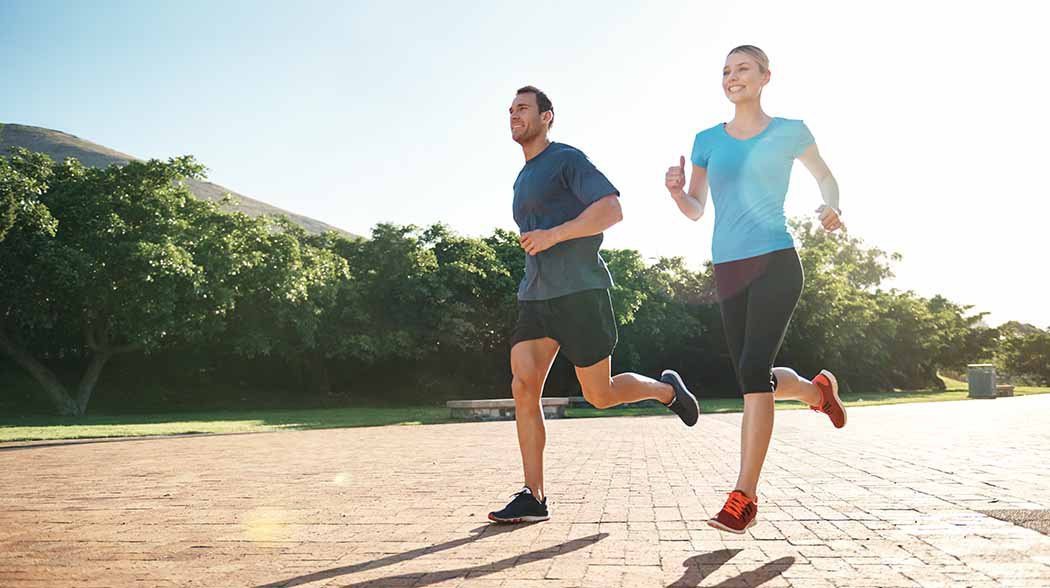 man and a woman jogging on a street