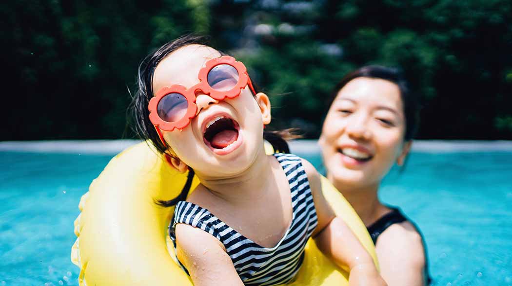 child and woman in a swimming pool