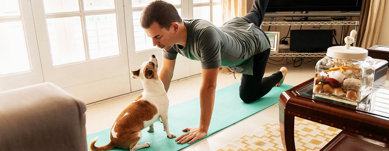 man exercising with dog