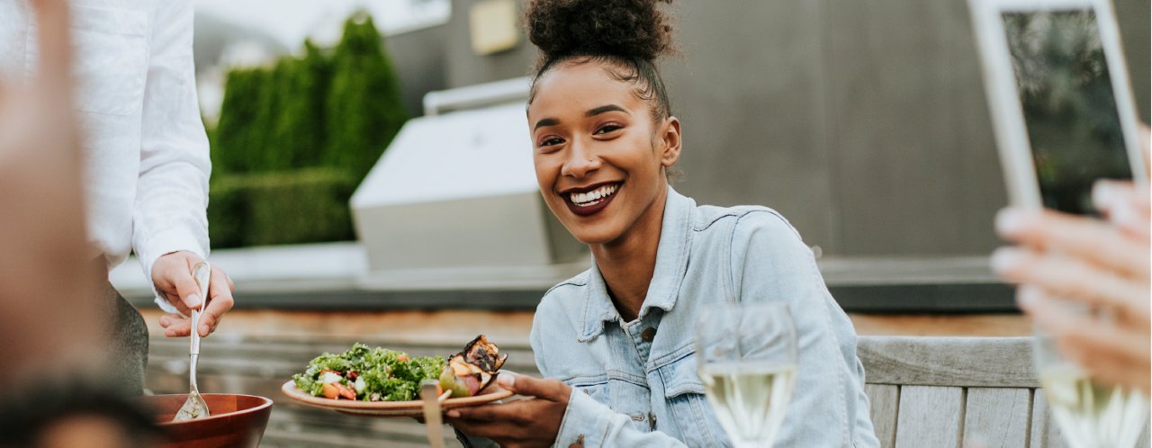 a woman having food on a table