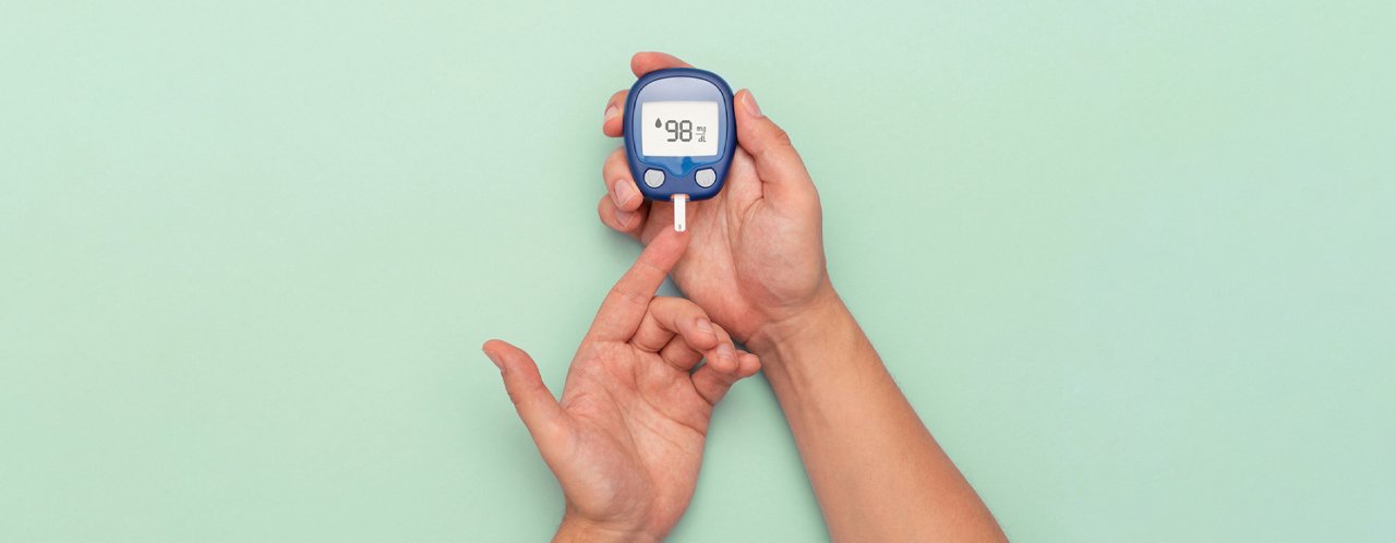 a person holding glucometer