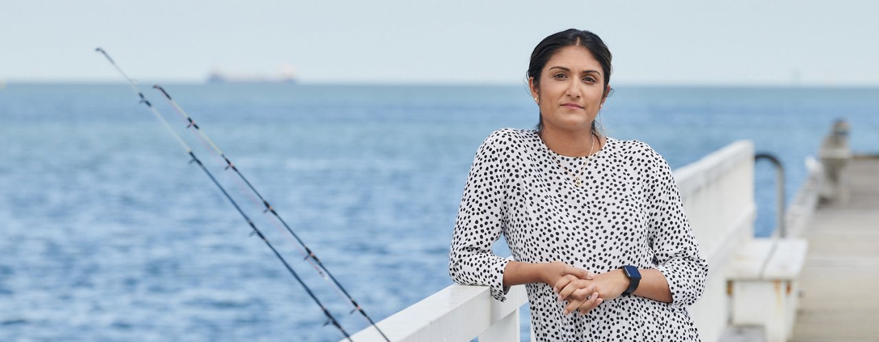 a woman standing near a ship railing