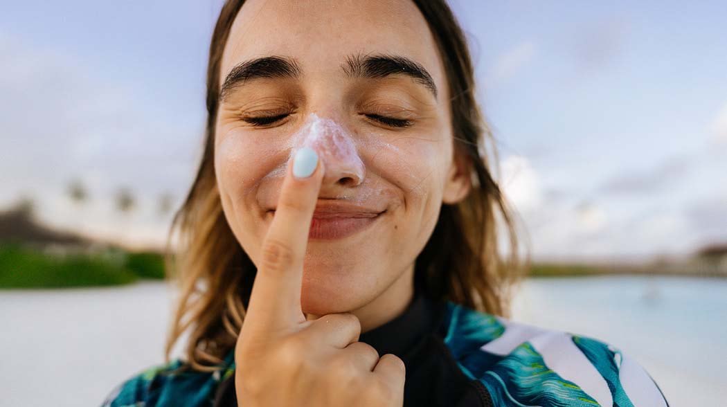 a female touching her nose