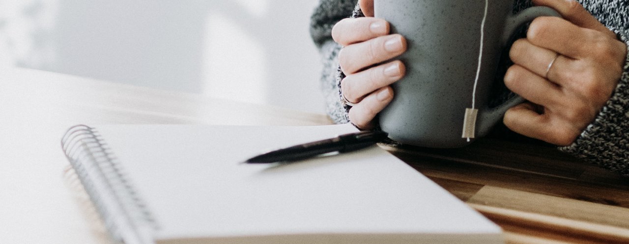 person holding coffee cup