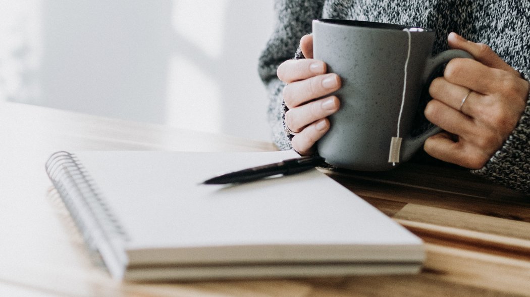 a person holding a coffee mug