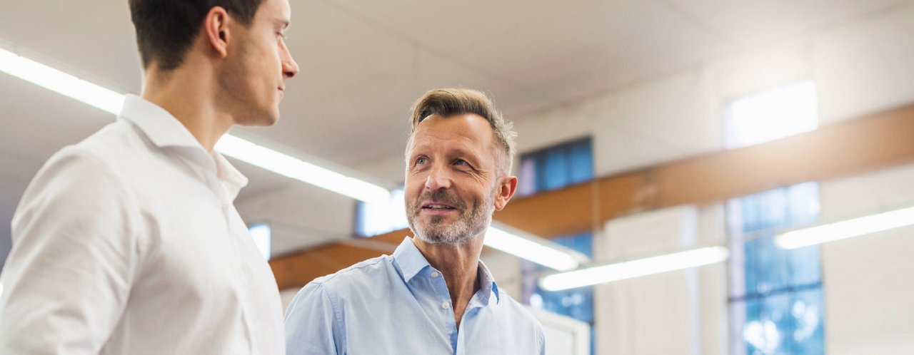 two men talking in office