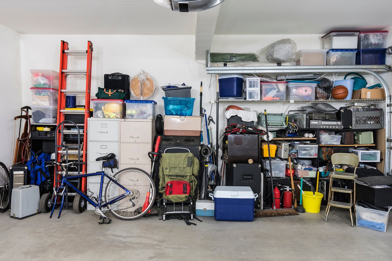 Garage with storage bins, tool boxes, filing cabinets and various equipment 
