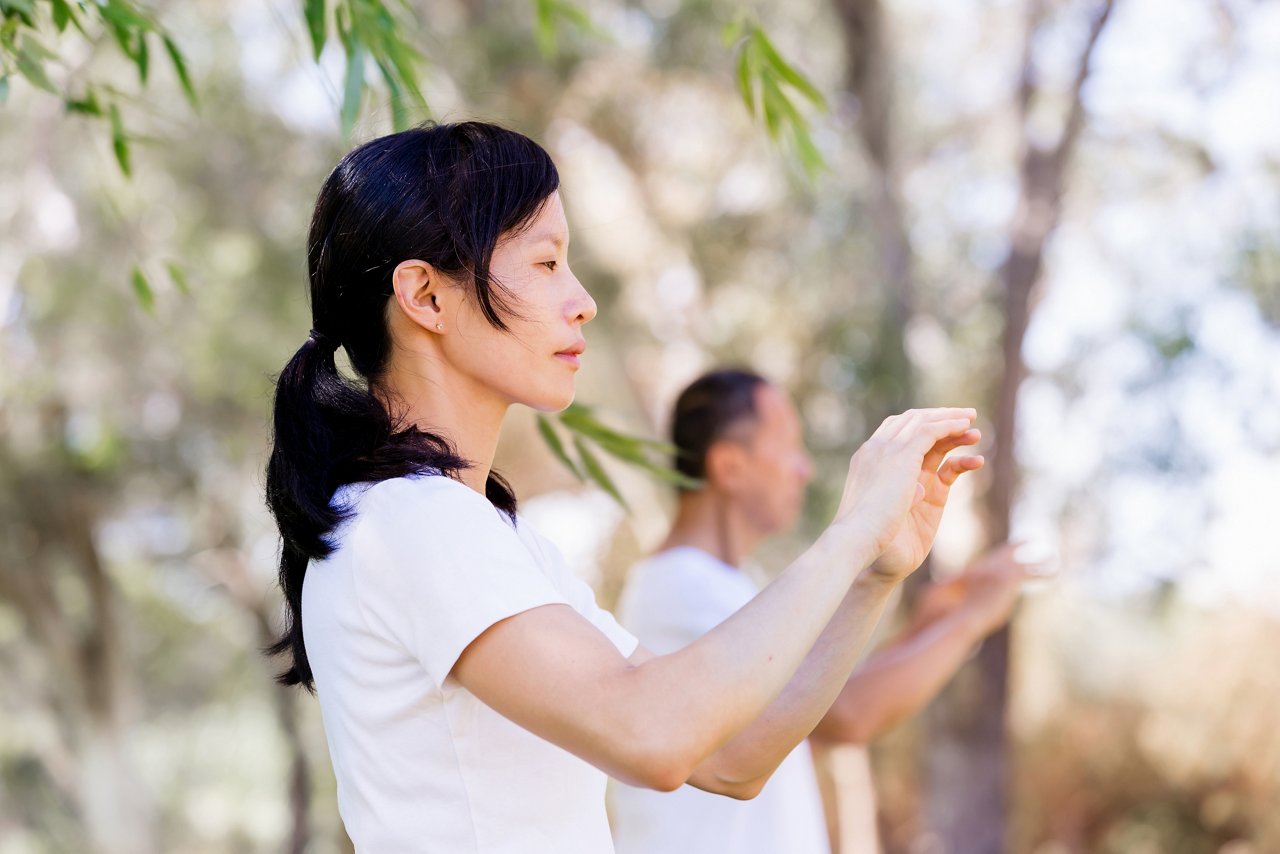 A woman doing tai chi outdoor at the park 