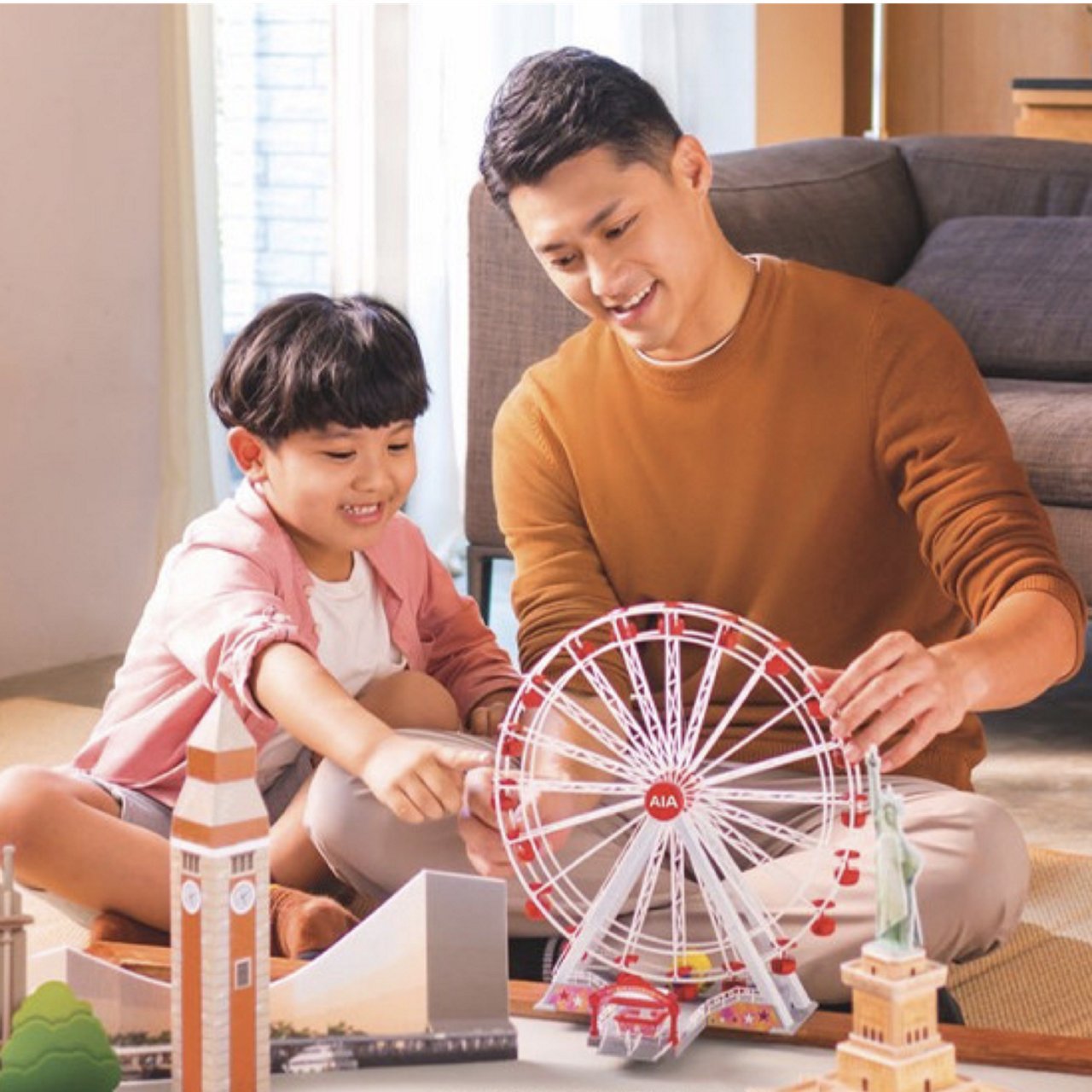 a man along with a child are playing with toys