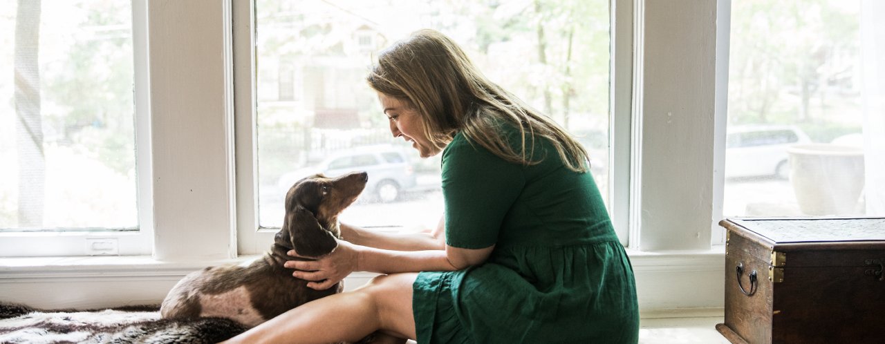 woman playing with dog