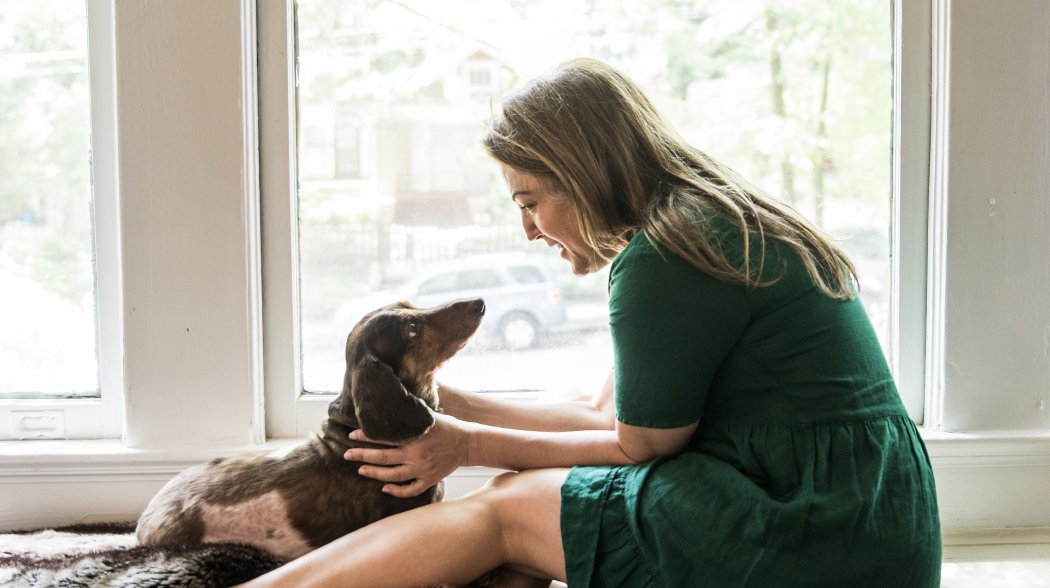 a woman looking at a dog