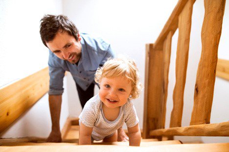 a man climbing staircase along with a kid