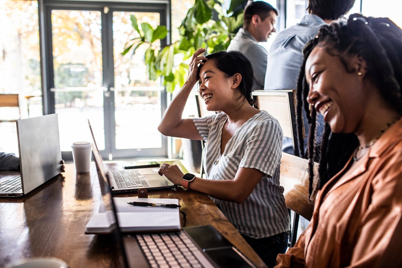Young professional women collaborating in coffeeshop
